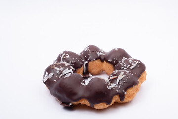 Chocolate Cream Donuts Sprinkled with Shredded Coconut. Chocolate Cream Donut on white background.