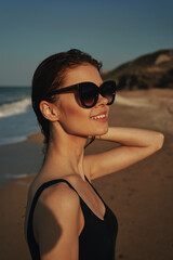 cheerful woman sunglasses posing black swimsuit island