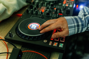 Fototapeta na wymiar DJ's hands mix music on the mixer close-up. DJ mixer, DJ mix music on the console, the DJ's hand