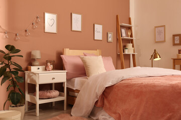 Teenage girl's bedroom interior with stylish furniture and beautiful decor elements