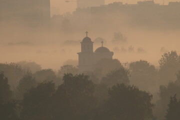 Cold morning with winter fog and church