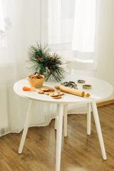 Christmas or New Year's pastries on a table decorated with pine branches. Christmas, gingerbread, molds for festive baking