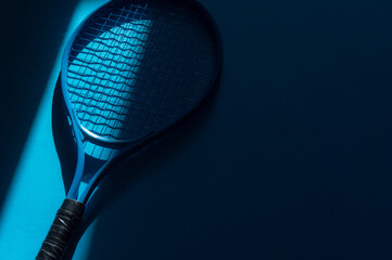 White professional  tennis racket with natural lighting on blue background. Horizontal sport theme poster, greeting cards, headers, website and app