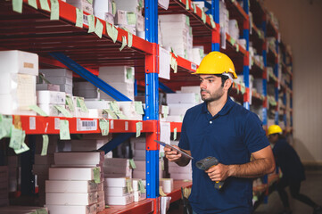 Handsome young male employee concentrating and focusing on work wearing safety helmet and uniform...