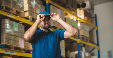 Handsome young male employee concentrating and focusing on work wearing safety helmet and uniform...