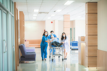Obraz premium Emergency Department staff push Gurney with Seriously heart attacked patient towards the Operating Room. Bright Modern Hospital with Professional Staff Saving Lives.
