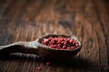 Red pepper on an ceramic spoon over wooden backround