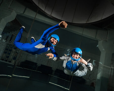 A man and a woman enjoy flying together in a wind tunnel. Free fall simulator