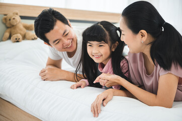 happy love family lifestyle with Asian father and mother and child daughter at home together