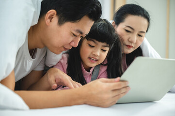 Obraz premium education at home, young mother and child family learning to work a homework with laptop