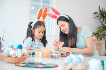 mother and child family making waster egg at home happy and fun together in holiday