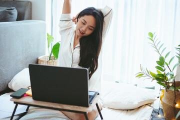 young Asian woman freelance working business work on laptop at home, working from home concept