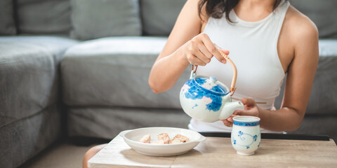 Asian woman person relaxing with hot tea to drink at home, tea cup for happy lifestyle in morning