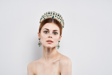 beautiful woman with a crown on her head makeup model close-up lifestyle