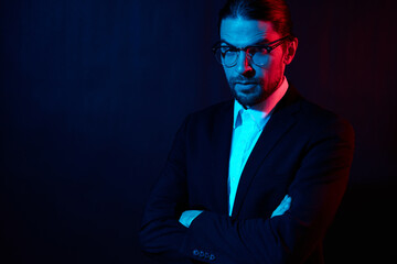 portrait of a man in costume posing fashion with glasses neon light