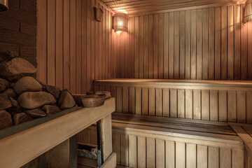 Fototapeta na wymiar Large standard design classic wooden russian bath sauna interior with hot stones