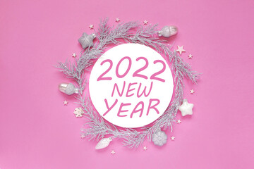 2022 NEW YEAR. Christmas composition with silver gifts. Blank white paper circle shape on pink background. Christmas pattern. Flat lay, top view, copy space - Image