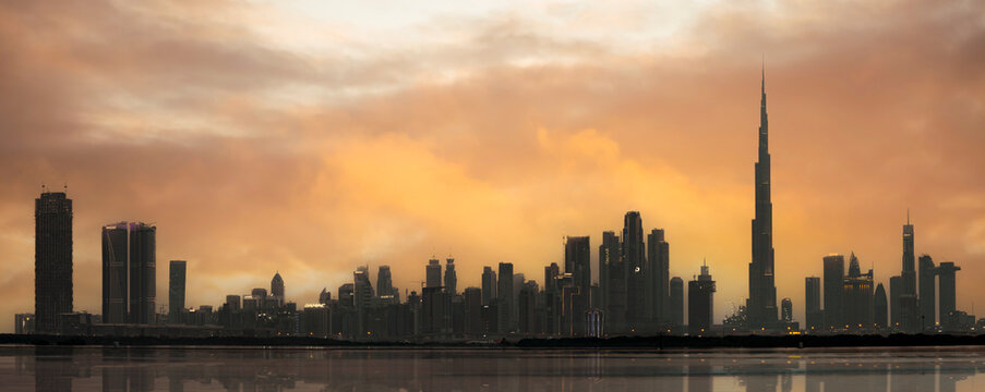 Stunning view of the silhouette of the Dubai Skyline during a dramatic sunset. Dubai, United Arab Emirates.