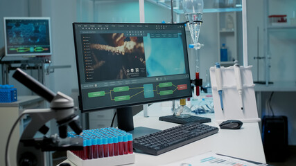 Empty laboratory with dna animation on computer and chemical equipment. Nobody in science room with...
