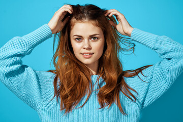 portrait of a woman in a blue sweater blue background Lifestyle