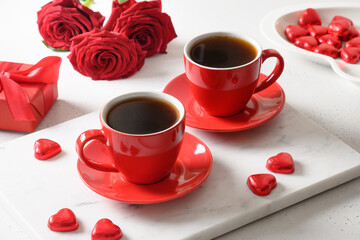 Fototapeta na wymiar Valentine's day dating with coffee, red chocolate sweets and roses on white. Close up. Romantic date for two.