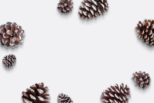 Pine cones composition with copy space in the middle. Top view, flat lay