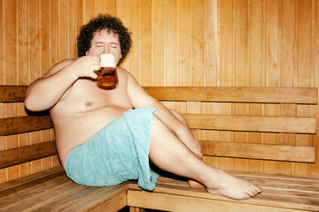 Funny fat man is relaxing in the sauna.