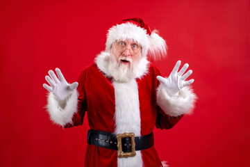Portrait real authentic surprised shocked Santa Claus Santa isolated on red studio background. Fulfillment of desires