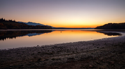 Lake sunrise landscape. Water reflection of mountains. Water reservoir Liptovska Mara at Slovakia