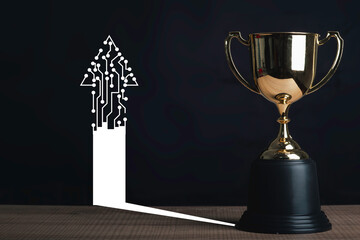 Trophy on table in black background with circuit board arrows.