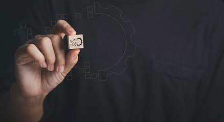 Hand holdding wood cube with gear digital transformation concept. Connection next generation technology and new era of innovation.