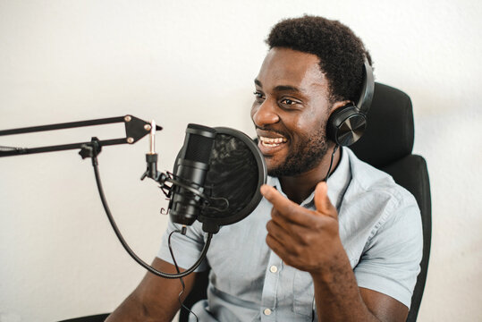 Delighted Black Man Recording Podcast And Talking In Mic