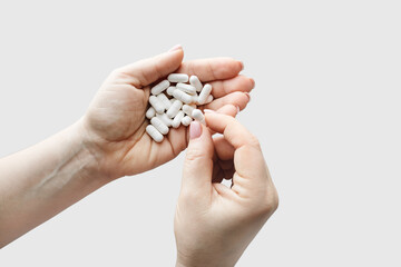 Pharmaceutical pills in female hands. Treatment concept.