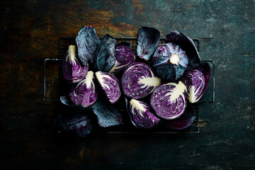 Vegetables. Fresh purple cabbage on a black stone retro table. Top view. Free copy space.