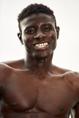 African man smiling after workout. He is in a park.