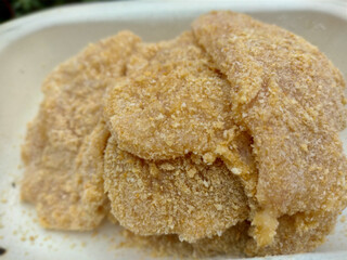 closeup of chicken steaks, breaded with flour, ready to be baked, fried. 