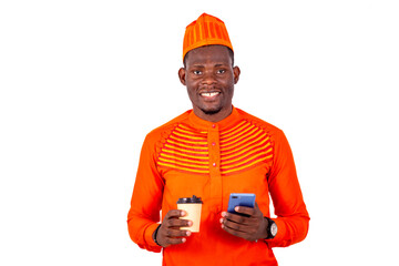 young business man holding mobile phone and cup of coffee.