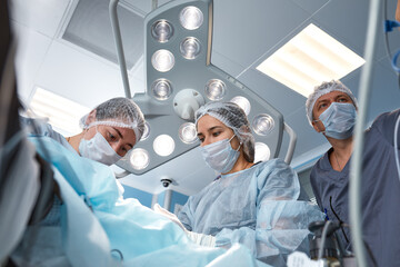 Concentrated Surgical team operating a patient in an operation theater. Well-trained anesthesiologist with years of training with complex machines follows the patient throughout the surgery