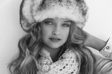 A teenage girl in a fur hat