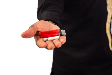 close up of male hand holding cigarette and lighter