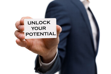 A businessman shows an inscription: UNLOCK YOUR POTENTIAL