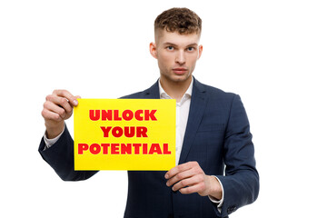 A businessman shows an inscription: UNLOCK YOUR POTENTIAL