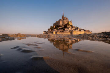 Fototapeta na wymiar View of famous Mont Saint Michel tidal island at a beautiful sunrise time in Normandy, Northern France