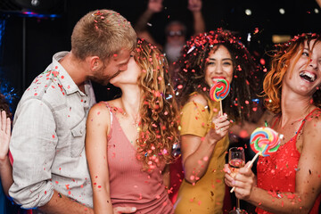 Young friends dancing at disco club party - Happy people having fun listening music at night