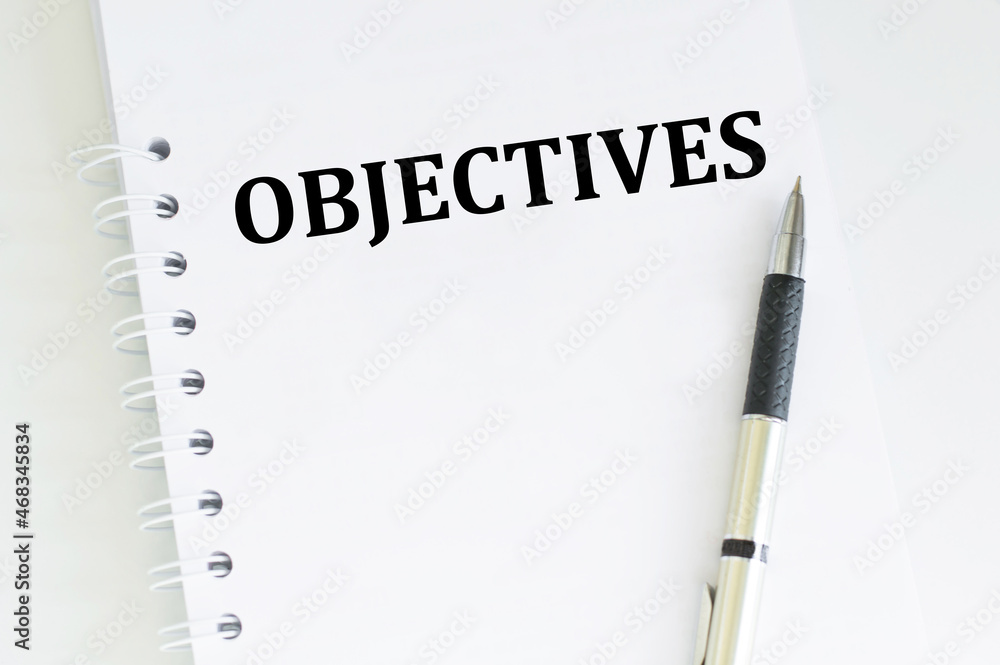 Poster notebook with text objective on table isolated, business concept, business goals