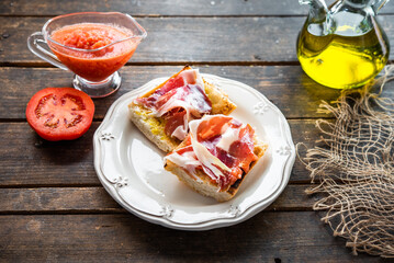 toasted bread with tomato and acorn-fed Iberian ham, typical Spanish tapa, healthy breakfast	