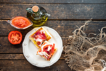 toasted bread with tomato and acorn-fed Iberian ham, typical Spanish tapa, healthy breakfast	