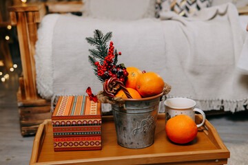 Tangerines, a gift box and Christmas decorations, lollipops on the table. The concept of a New...