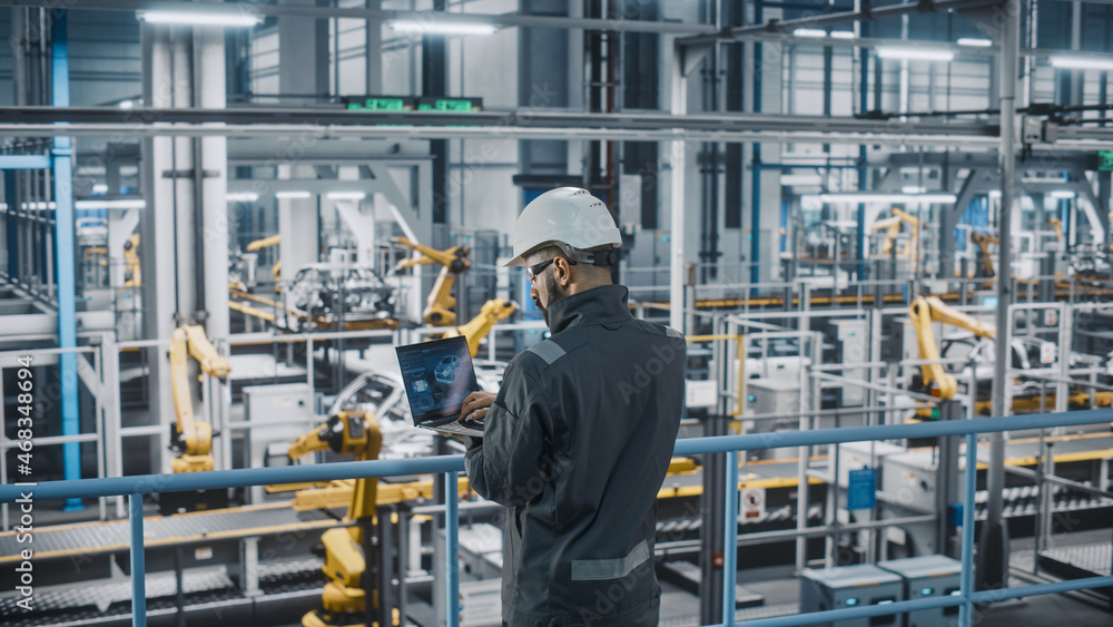 Poster car factory engineer in work uniform using laptop computer. automotive industrial manufacturing faci