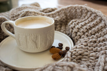 Cup of coffee wrapped in a blanket